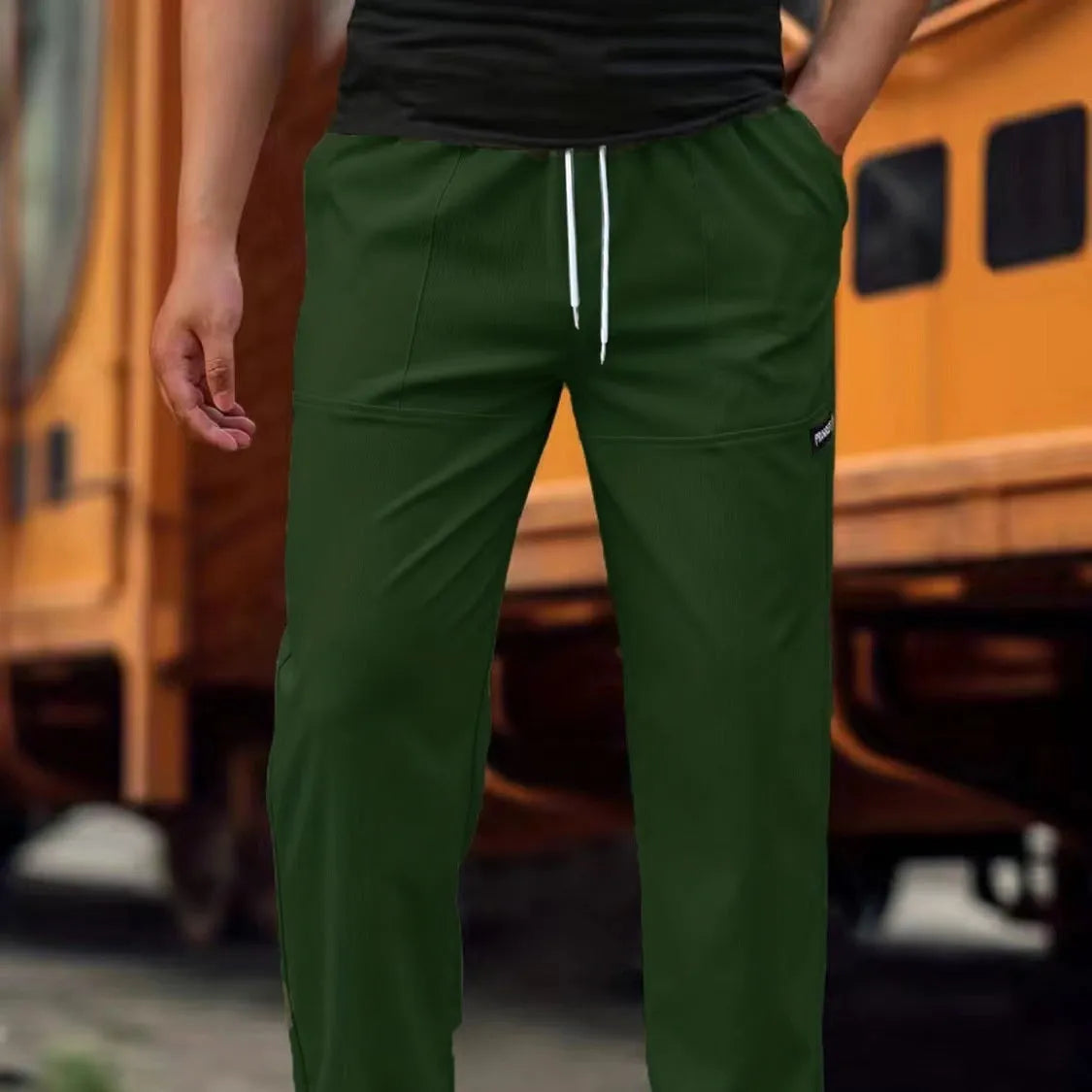 Men's light grey polyester trousers for spring and autumn seasons laid flat.