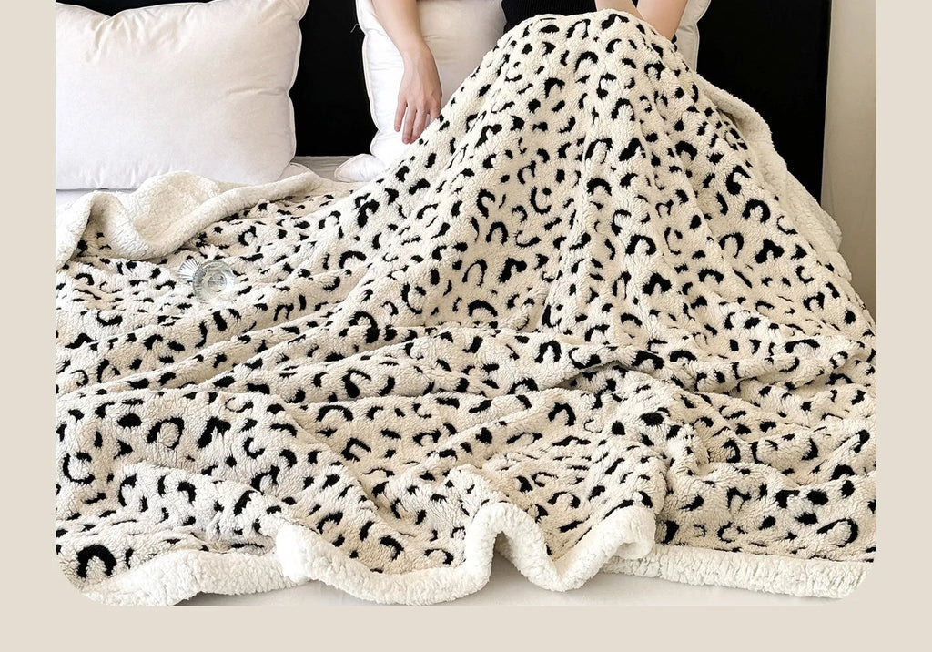Double-layer taffeta blanket with reversible leopard jacquard print design shown in camel colour