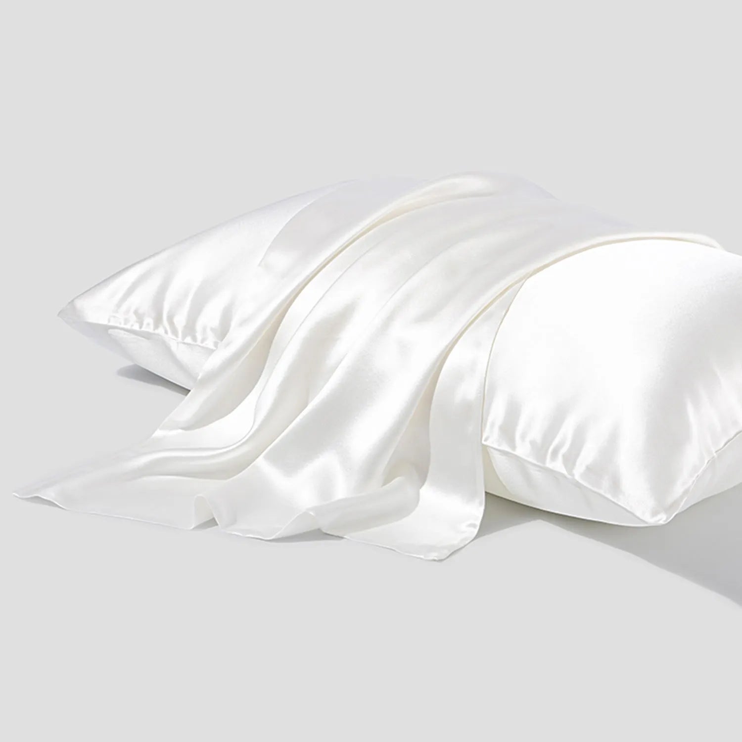 Dark grey 19 momme mulberry silk pillowcase showing envelope closure on a bed.