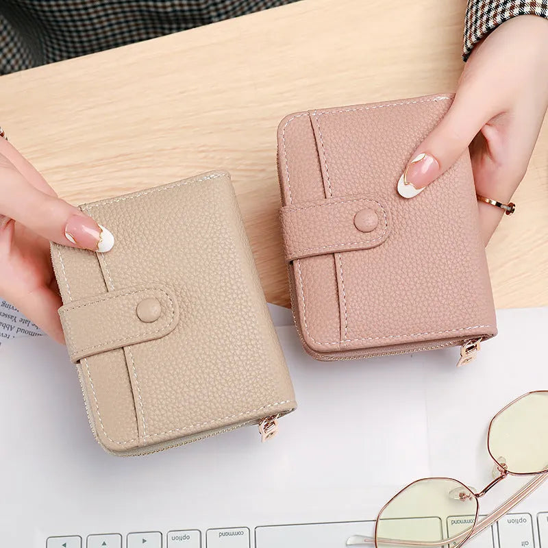 Ladies' short two-fold wallet with textured lychee pattern in beige, pink, black, and red colour options.