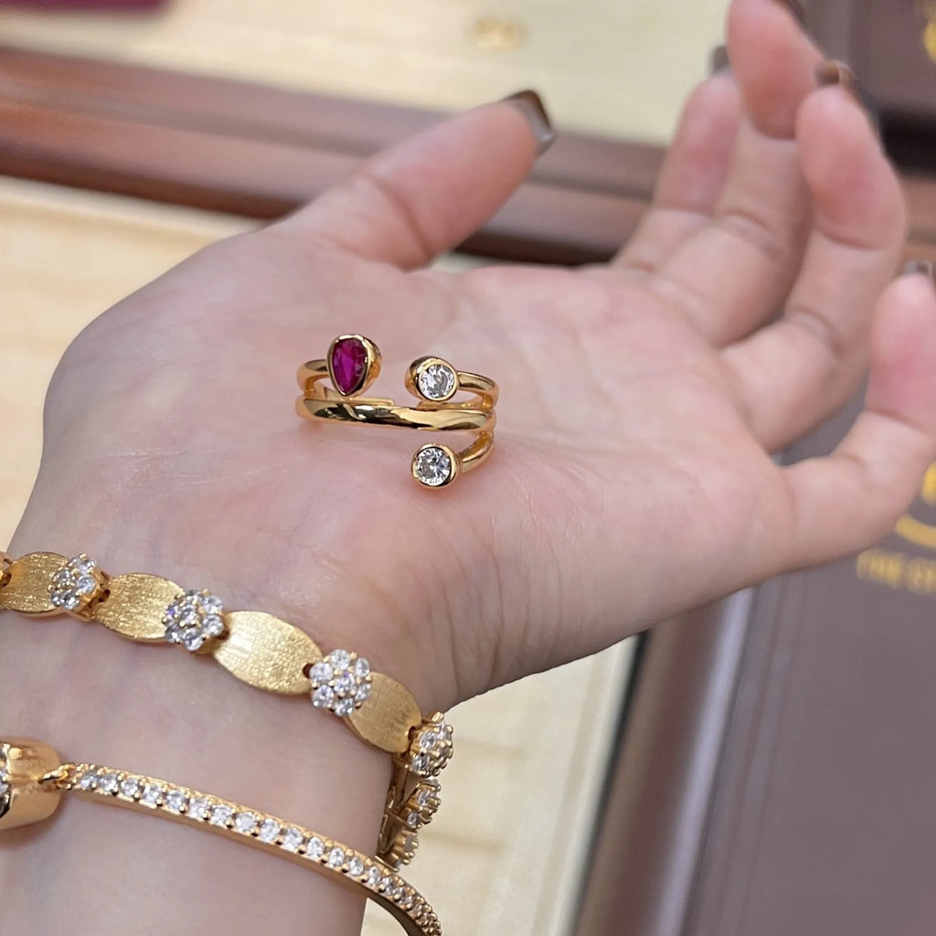 Copper double-headed ring with irregular cross geometric shape and diamond details in two-tone colours.
