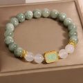 Oil green emerald crystal bracelet with five engraved Buddhist scripture beads on female wrist