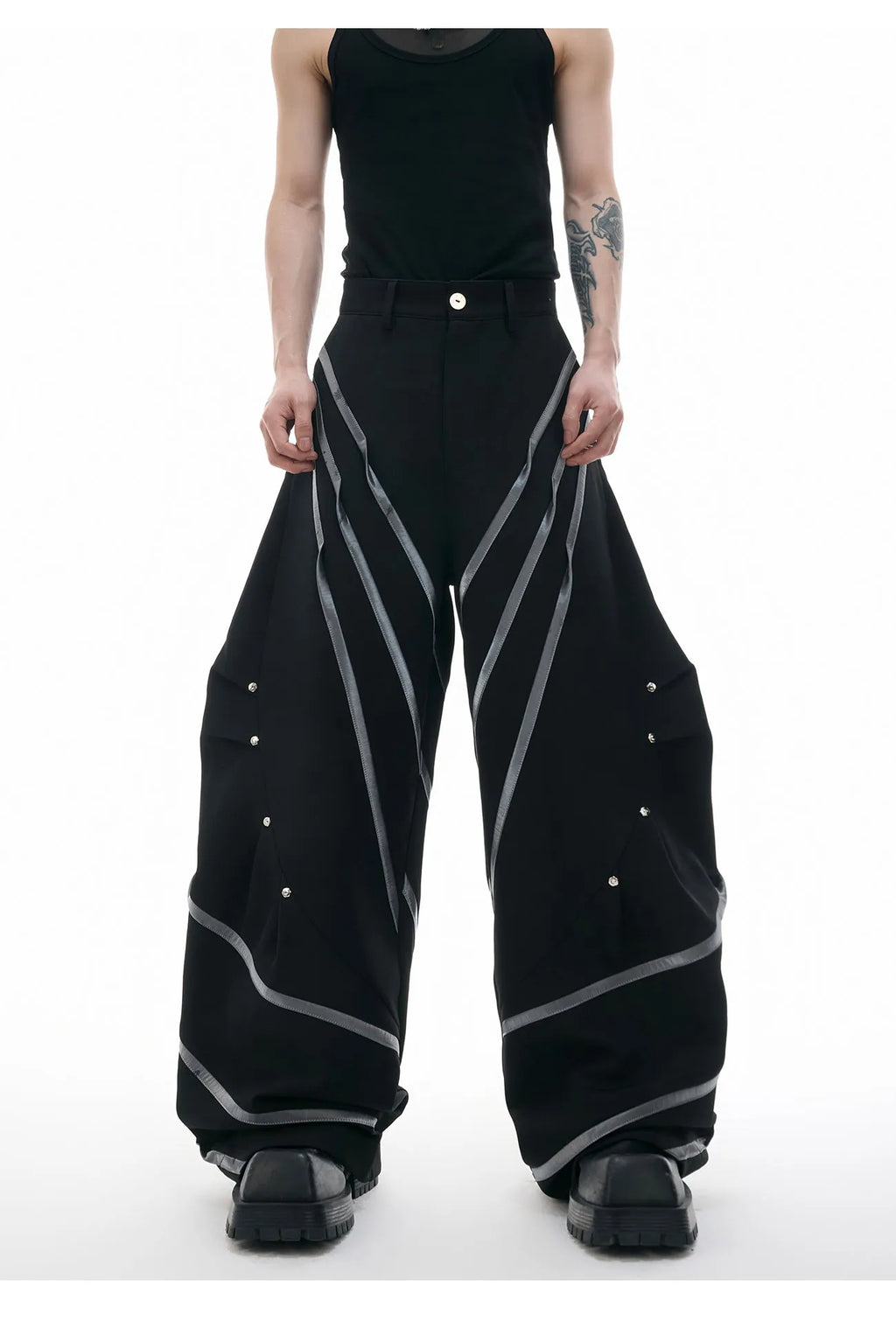 Men's polyester trousers with metal striped rivets and pleated detailing in black or white options