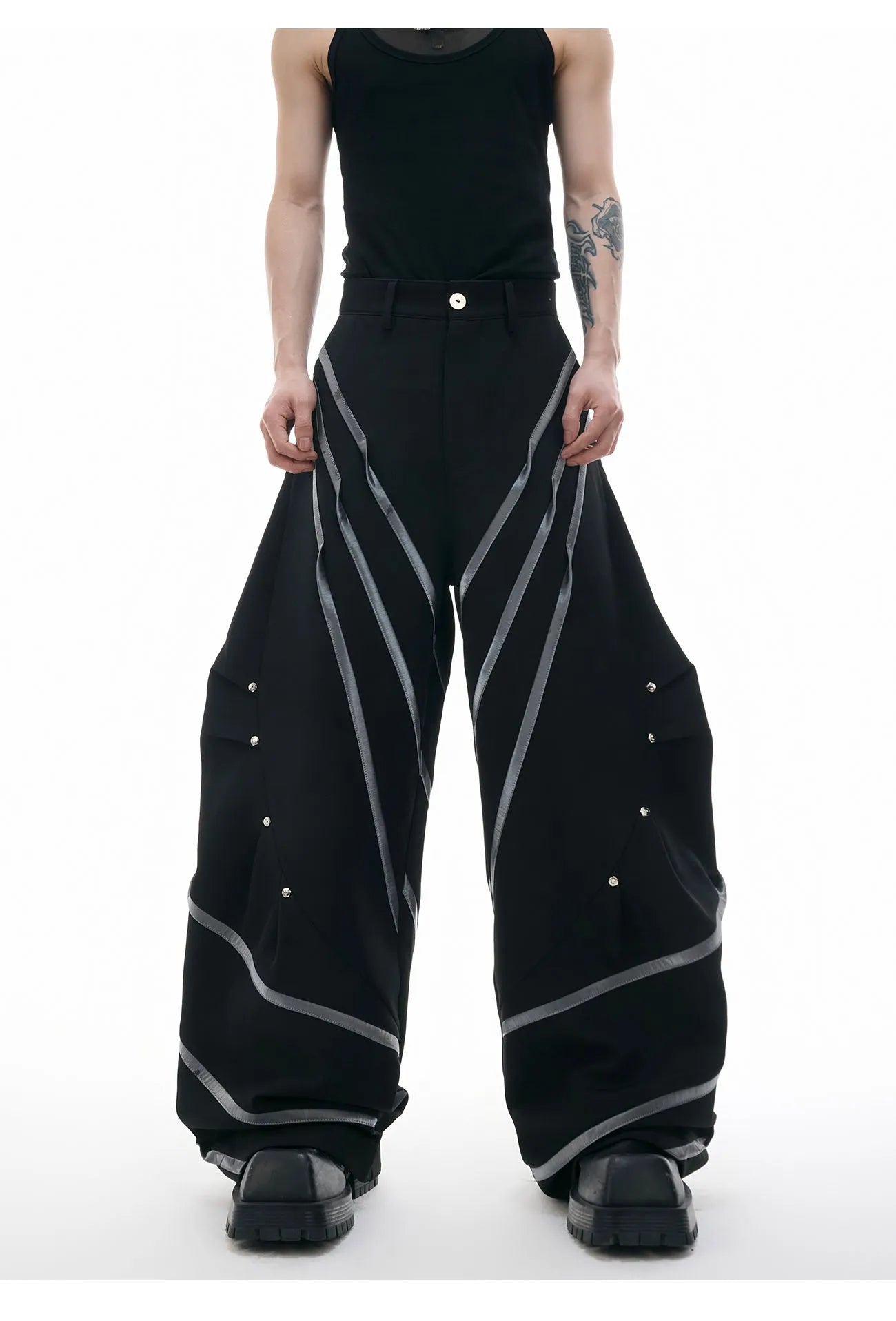 Men's polyester trousers with metal striped rivets and pleated detailing in black or white options