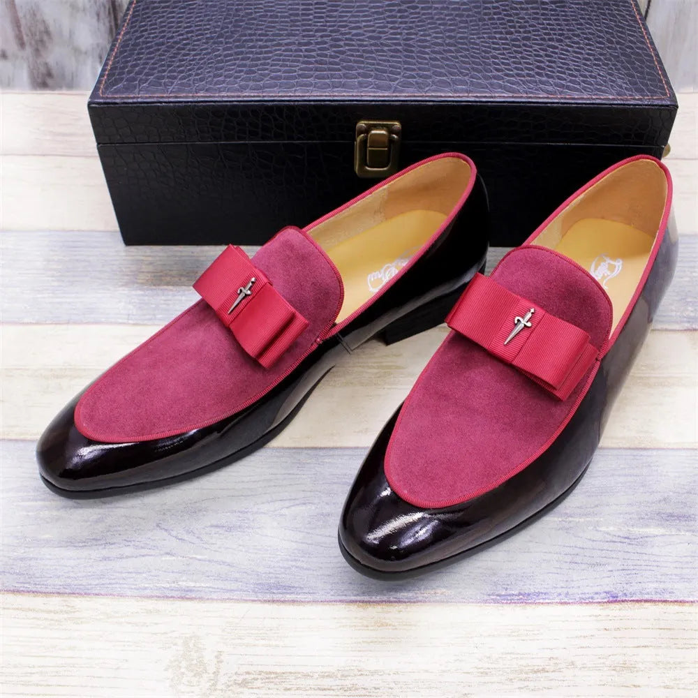 Men's black leather shoes with patent leather finish and a decorative tassel on the front.
