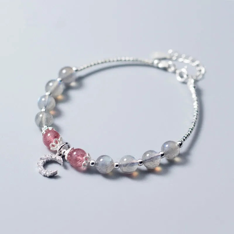 Handmade silver-toned bracelet with a blue-grey 6mm moonstone bead, small crescent moon charm, and clear crystal on an adjustable chain.