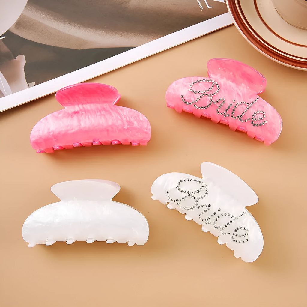 Pink and white acrylic shower shark hair clips with diamond embellishments and English letter details