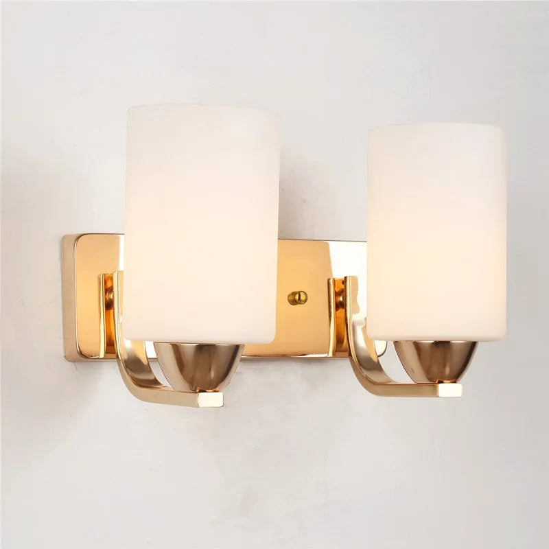 Chrome-finished wall lamp with glass shade in single head and double head configurations.