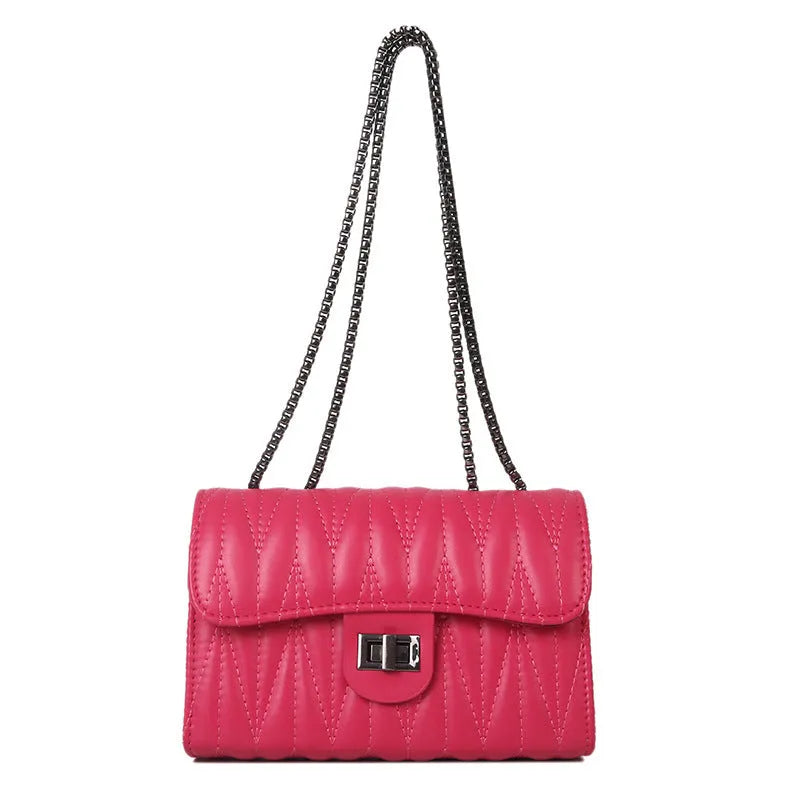 Small beige women's crossbody bag with diamond quilting and a single shoulder strap.