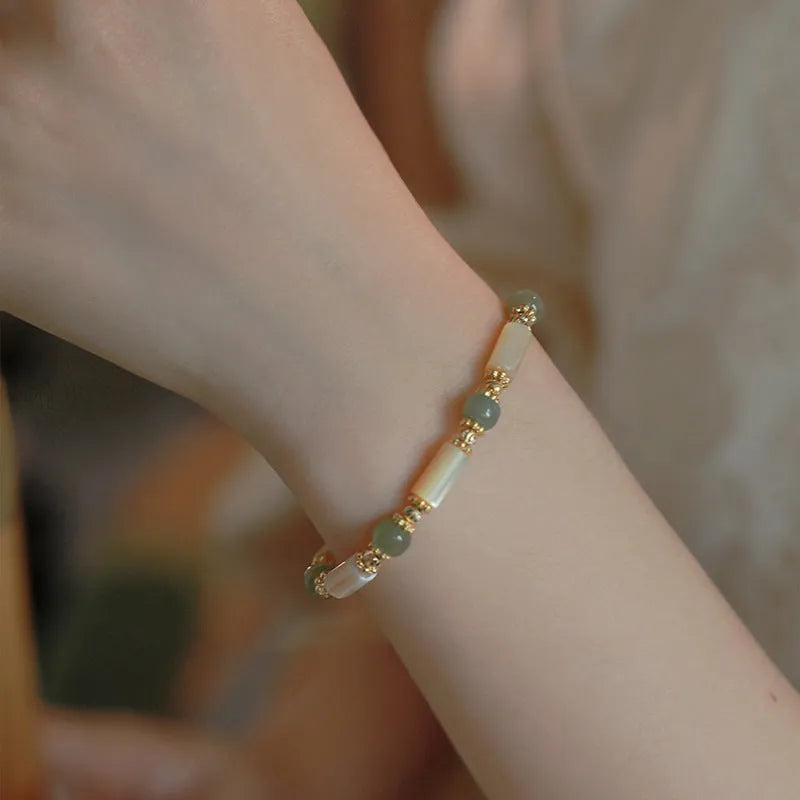 Natural white Hetian jade bead bracelet with geometric round beads on wrist