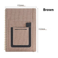 Erasable coil notebook with custom cover on thick waterproof stone paper, shown with pen and cloth.