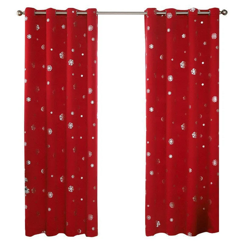 Red snowflake pattern shade cloth curtain with lace loops hanging against window