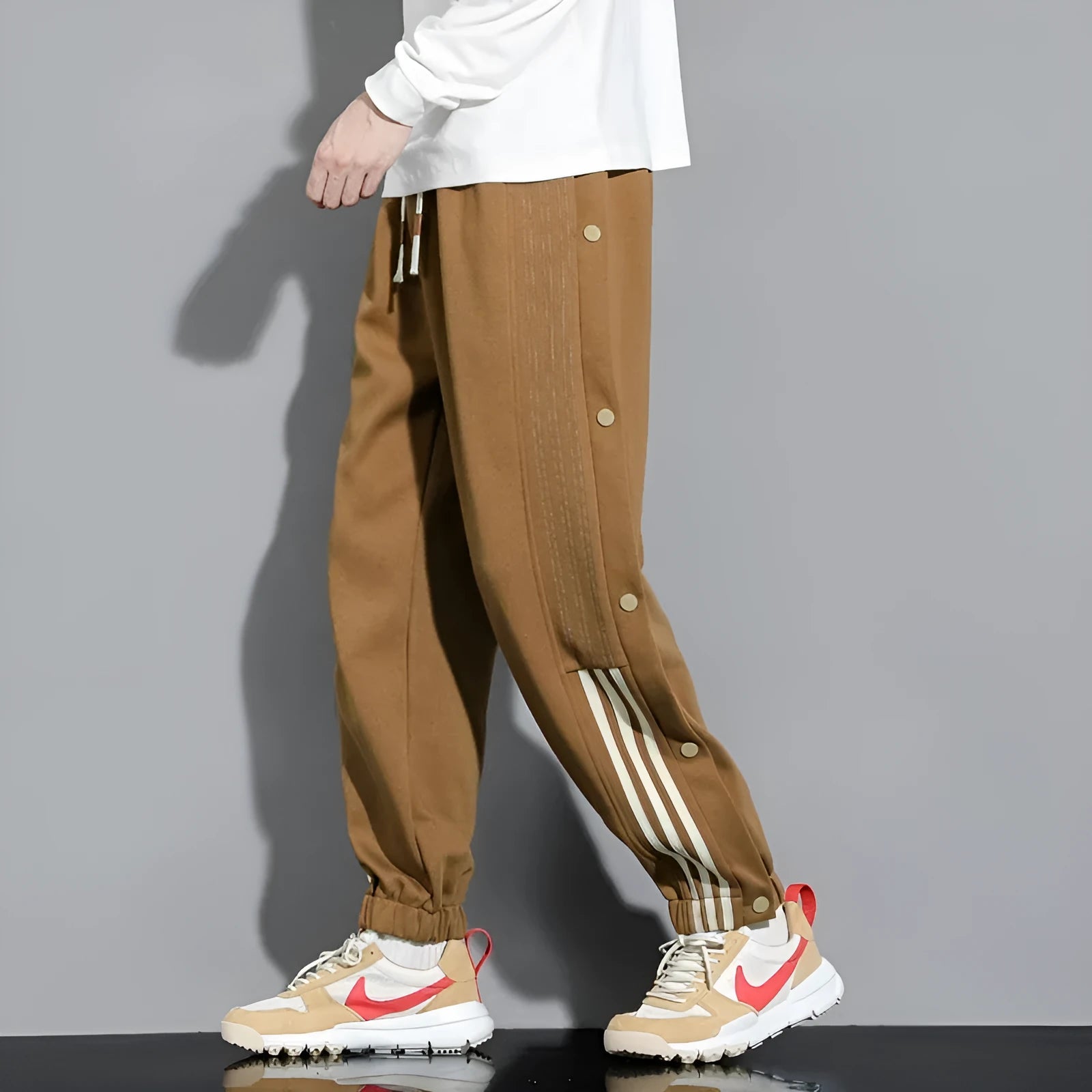 Men's loose grey sweatpants with ankle ties and a drawstring waist