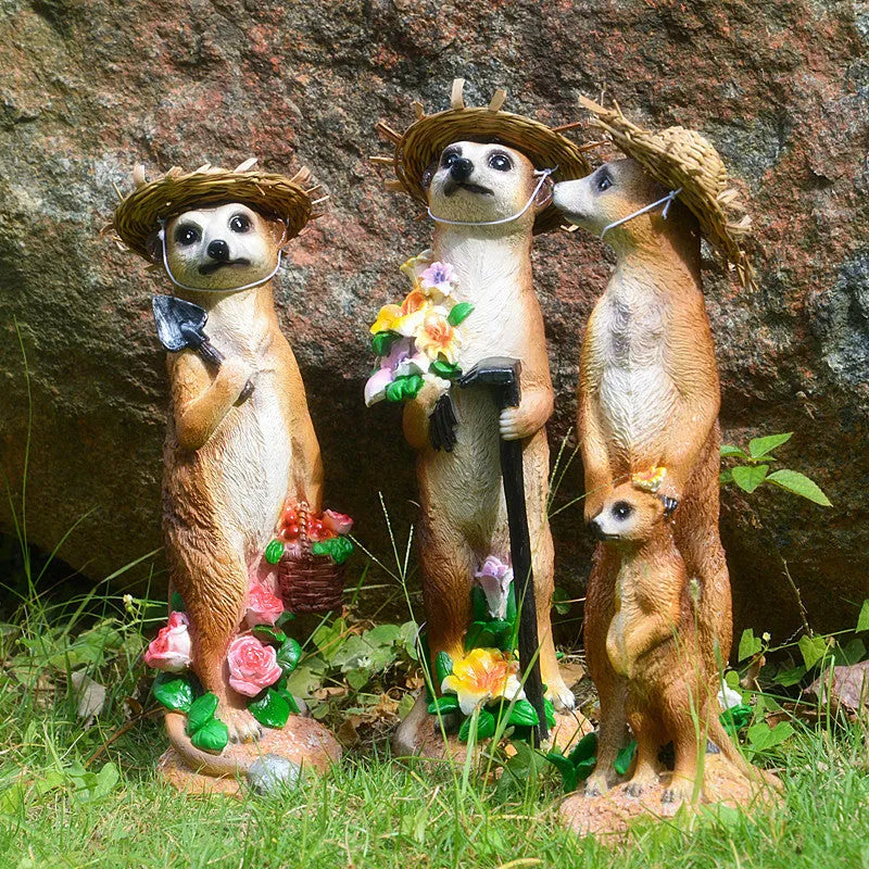 Three straw hat mongoose resin ornaments: mother and son, with rake, and with shovel figurines.