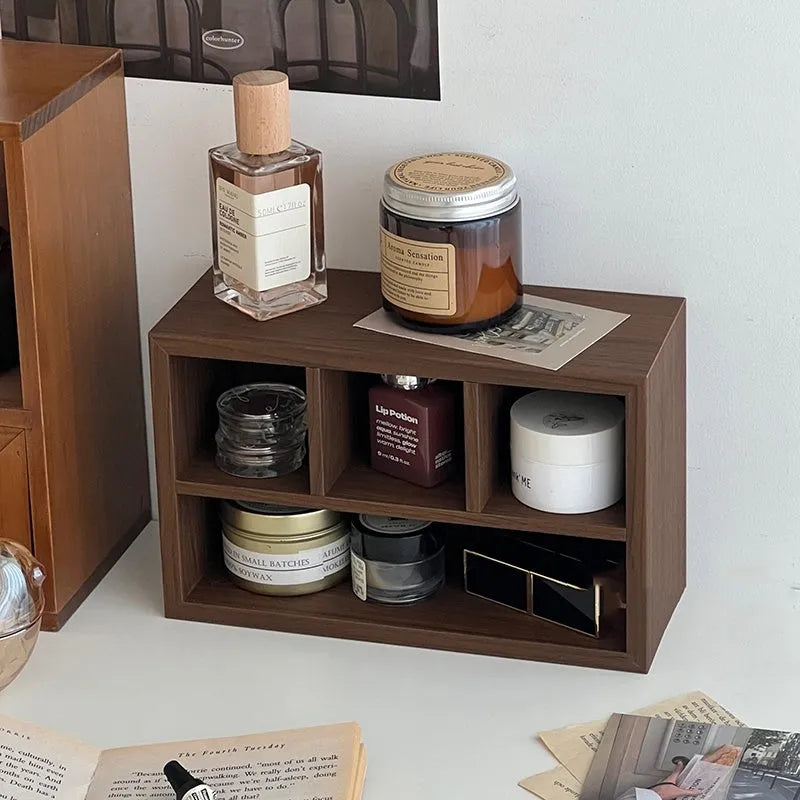 Retro wood desktop grid storage box with four short cells on a desk organising pens and sundries