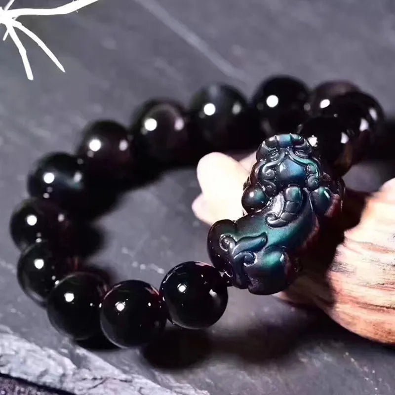 Natural eye obsidian crystal bracelet in ice colour on a wrist, showing bead sizing options.