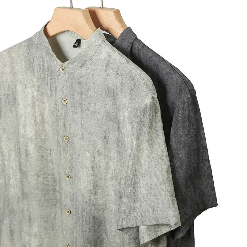 Man wearing a loose-fit black grey linen blend cardigan shirt with a stand collar.