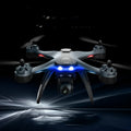 F5 smart ESC quadrocopter drone with dual cameras, remote controller, spare blades, and landing gear on a table.