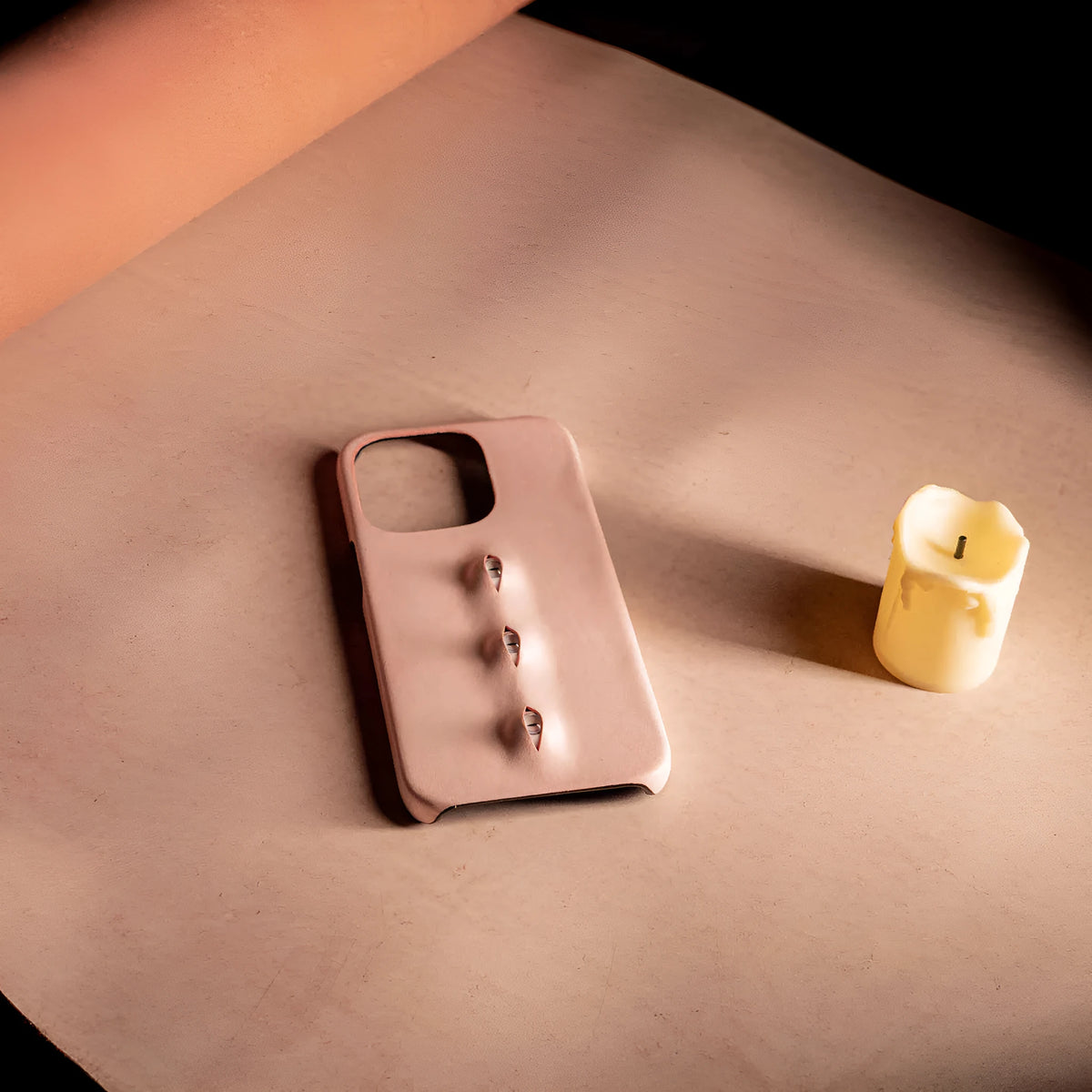 Pink eye-shaped handmade iPhone case in waxed vegetable-tanned cowhide with PC bottom case