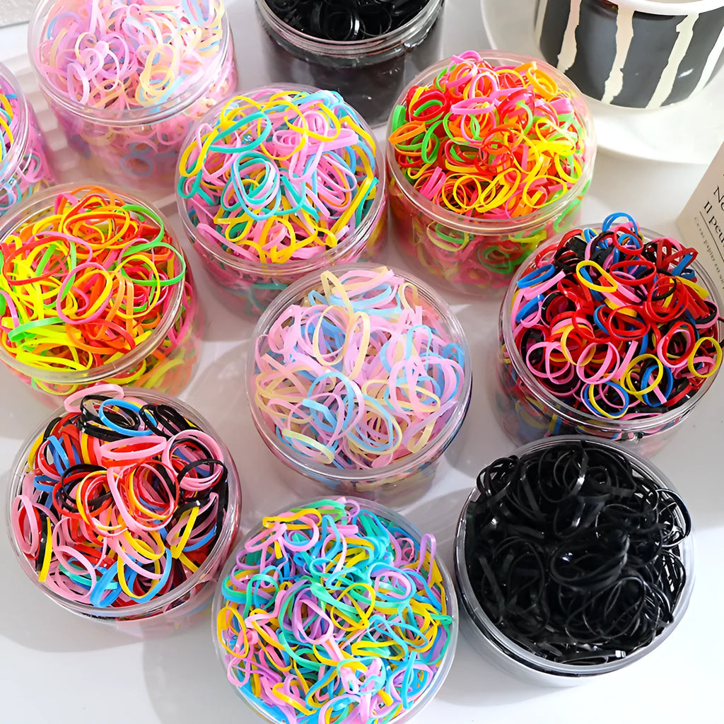 Pack of multicolour TPU baby hair ties in a reusable plastic storage container.