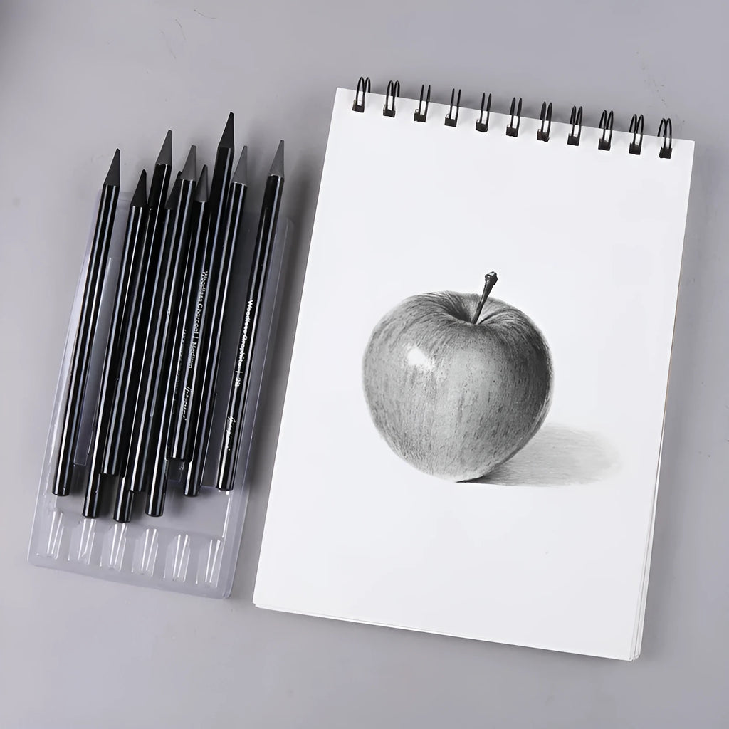 Carbonised and graphite drawing pencil set of nine in a wooden case, showing six graphite and three carbonised pencils.
