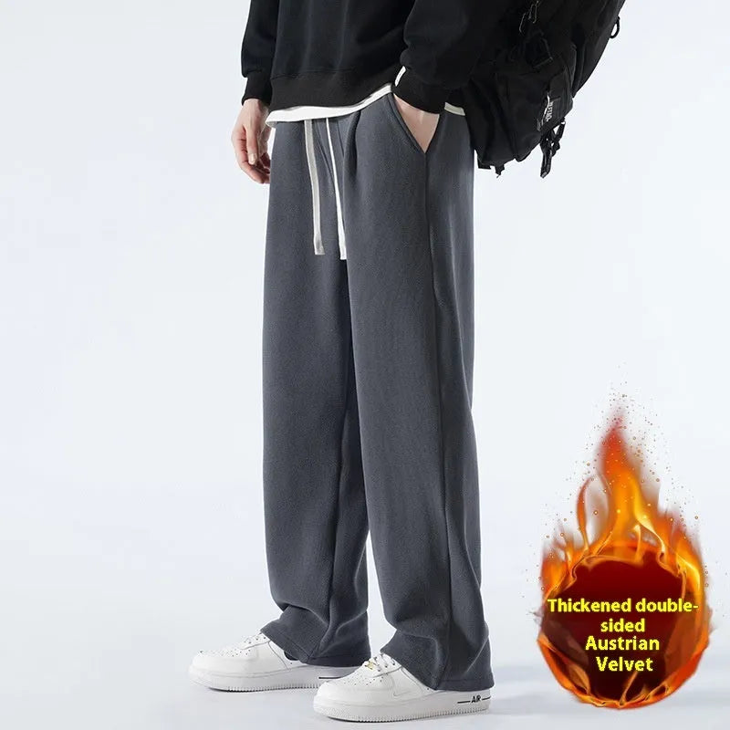 Men's loose fit apricot coloured fleece-lined sports pants with a drawstring waist on a hanger