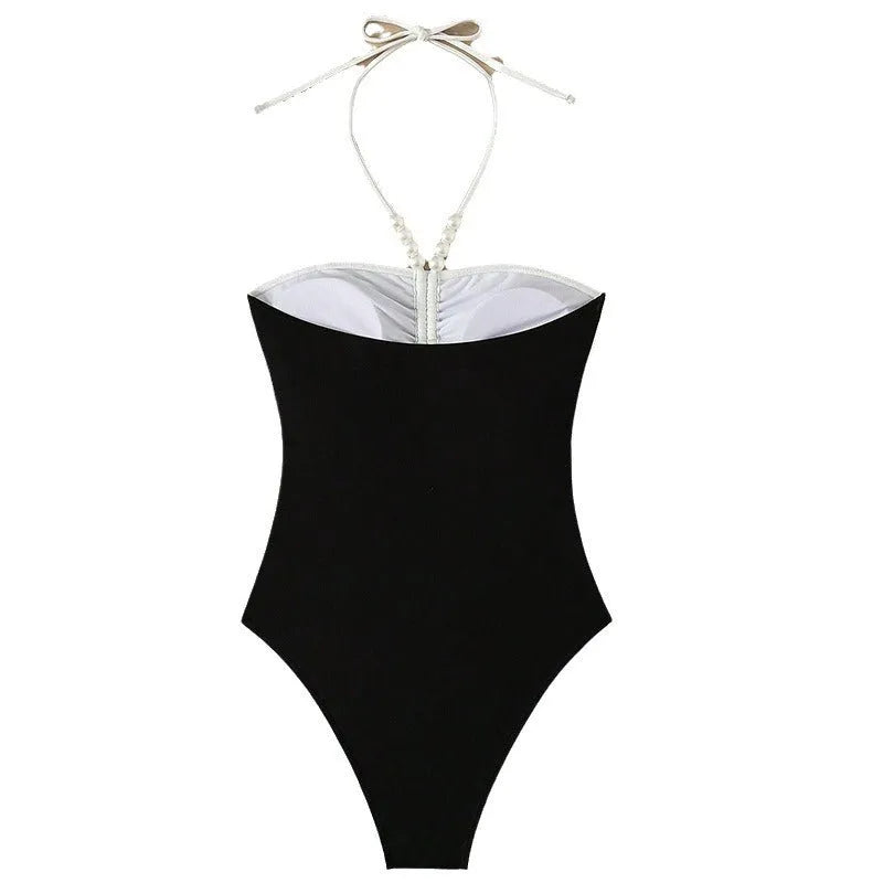 Black and white women's one-piece swimsuit with pearl spaghetti straps, sleeveless design
