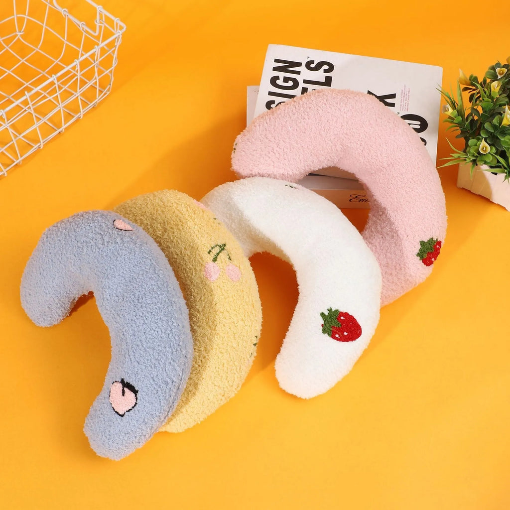 Blue U-shaped half moon pillow with cartoon dog print for pet carriers and cages.