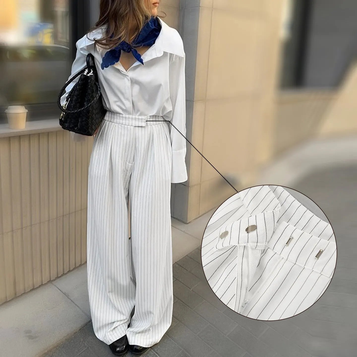 White striped wide-leg women's trousers with a front zip closure on a model