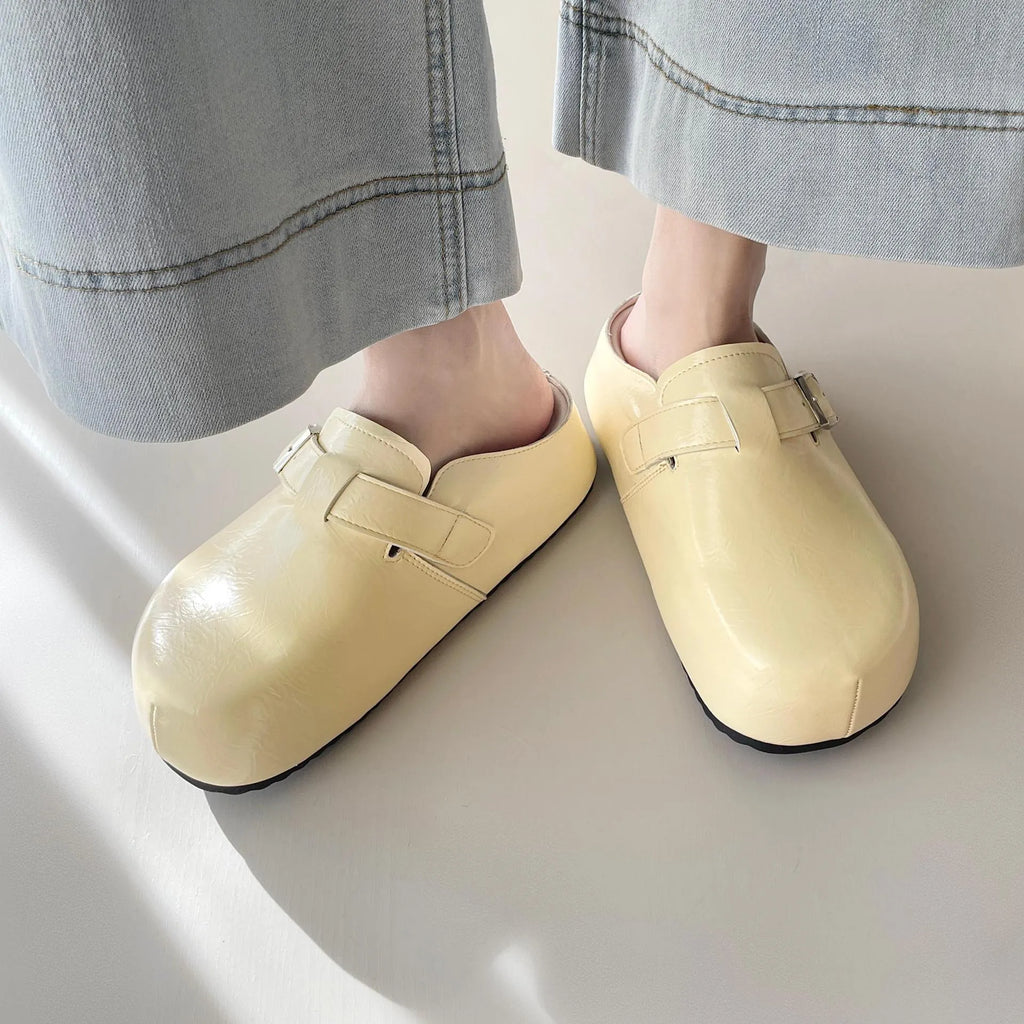 Flat buckle casual sneakers in yellow, creamy-white, silver, and black colours showing round toe and buckle detail.