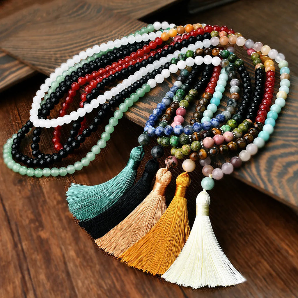 Long 108-bead natural stone necklace with colour-matched tassels and a geometric gem-inlaid pendant on a ball bead chain.