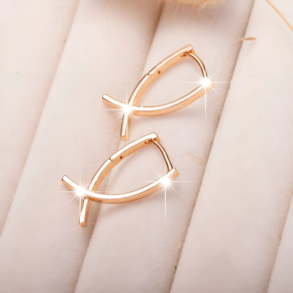 Rose gold coloured cross shaped drop earrings with contemporary light luxury styling