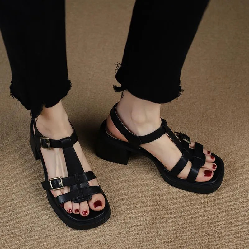 Black women's retro sandals with T-shaped buckle, open toe, chunky platform heel, and square toe shape.