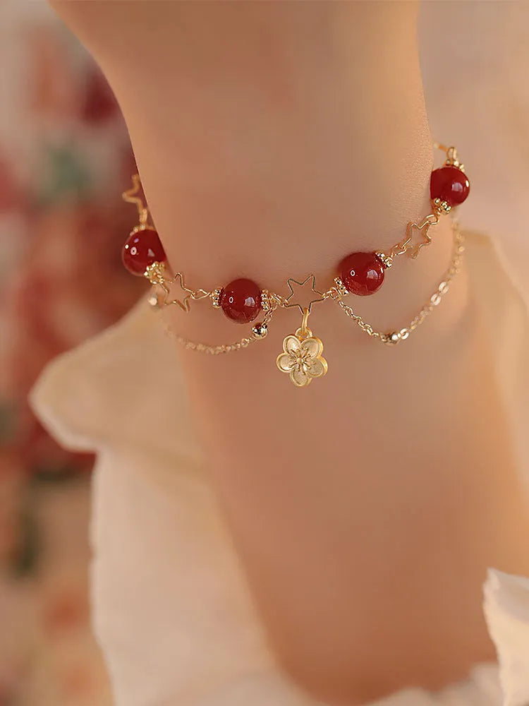 Close-up of natural red agate double layer bracelet with manual floral and peach blossom details for women.
