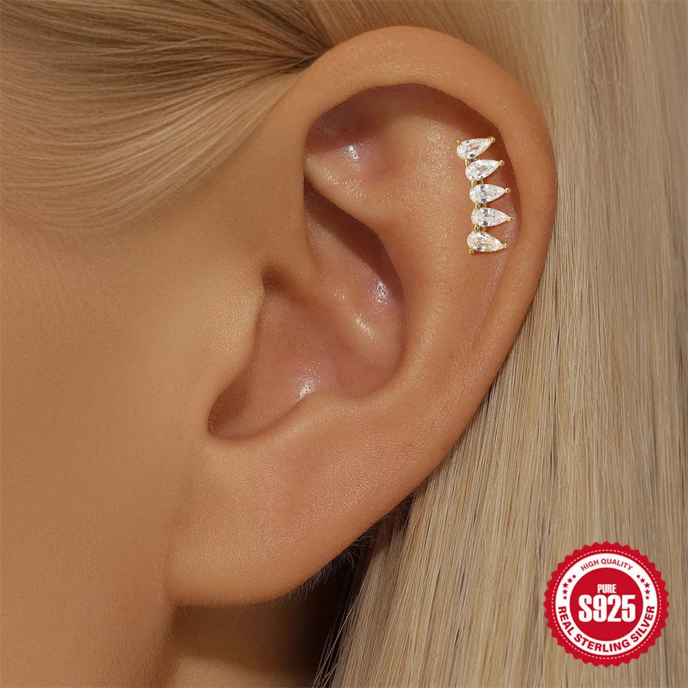 S925 sterling silver geometric moon and star earrings with embedded diamonds on a gold-coloured background.