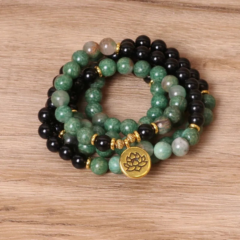 Green and black elastic beaded alloy bracelet on wrist showing natural style design