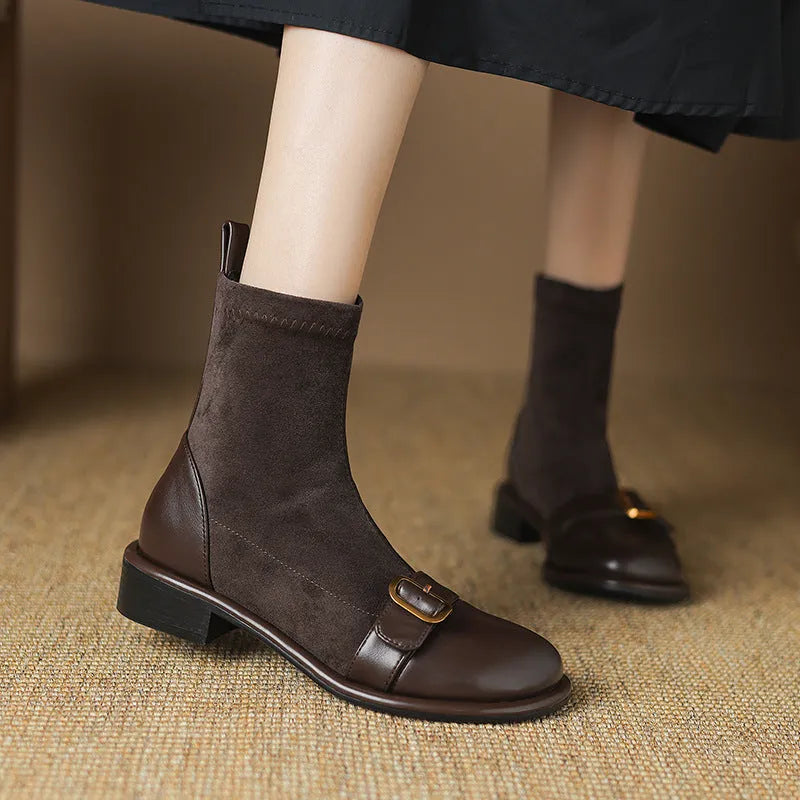 Women's black low heel Martin-style ankle boots with belt buckle stitching and front lace-up fastening.