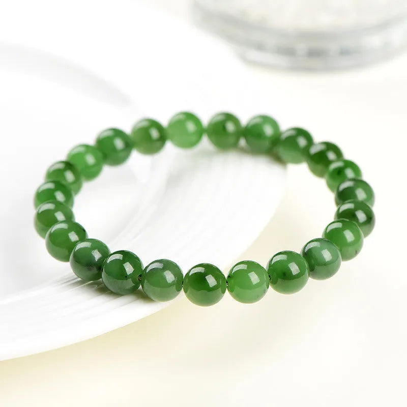 Natural Hetian jade jasper ball bracelet with polished beads on a wrist.