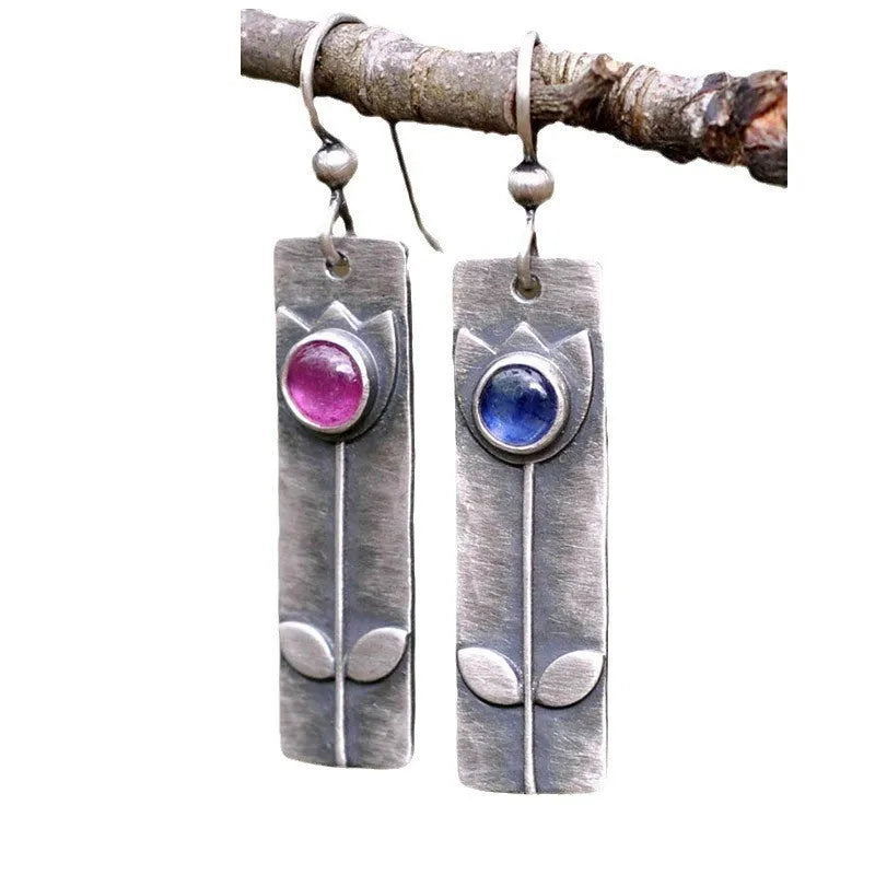 Geometric antique finish red sapphire earrings with elliptical elements and electroplated metal construction