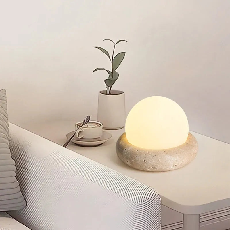 Modern simple bedside night light with remote control on a table.