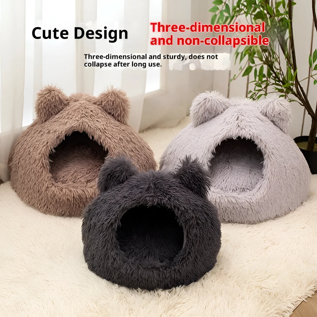 Large semi-closed flannel cat nest in dark gray on a floor, with soft plush interior visible