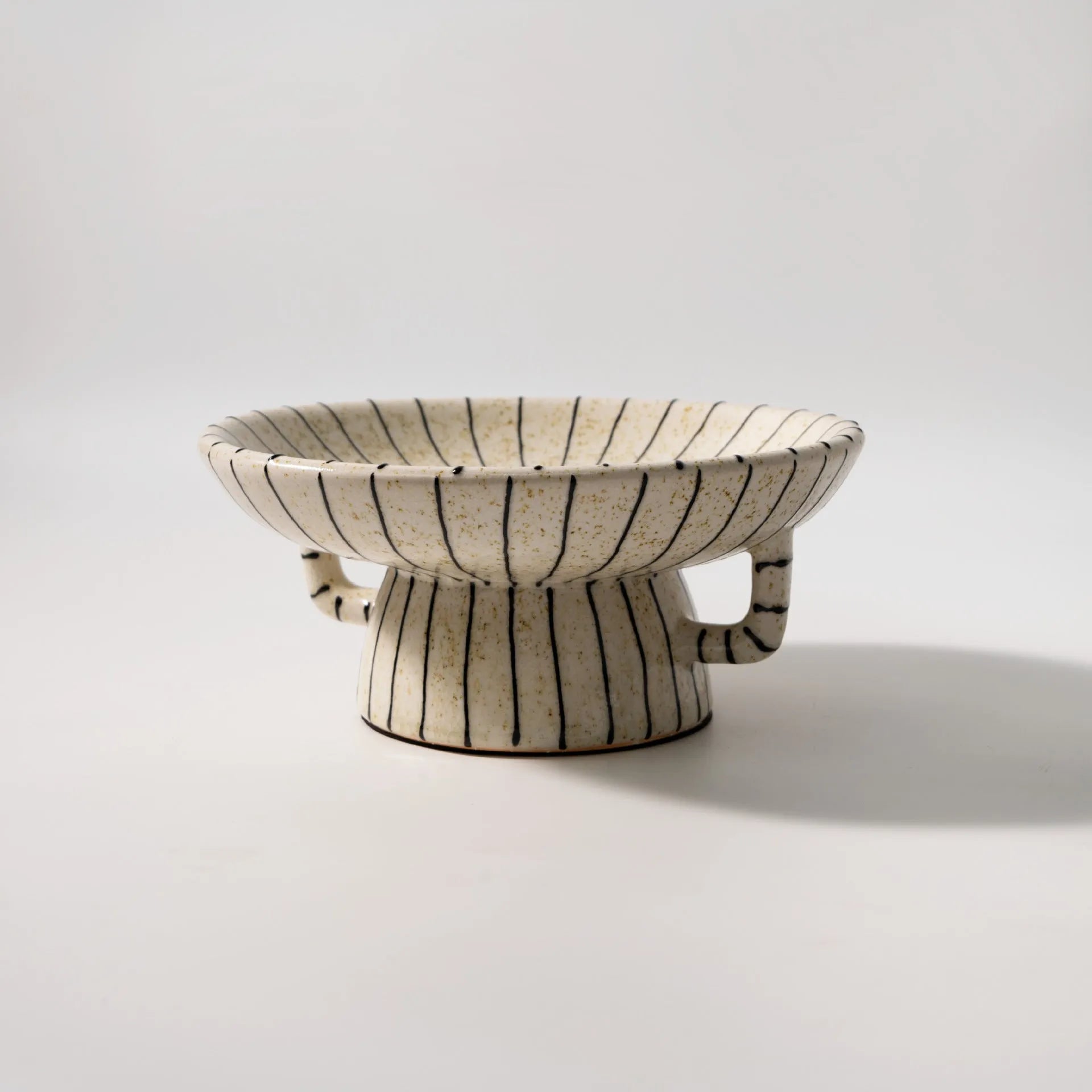 Black and white striped retro resin fruit plate on a table.