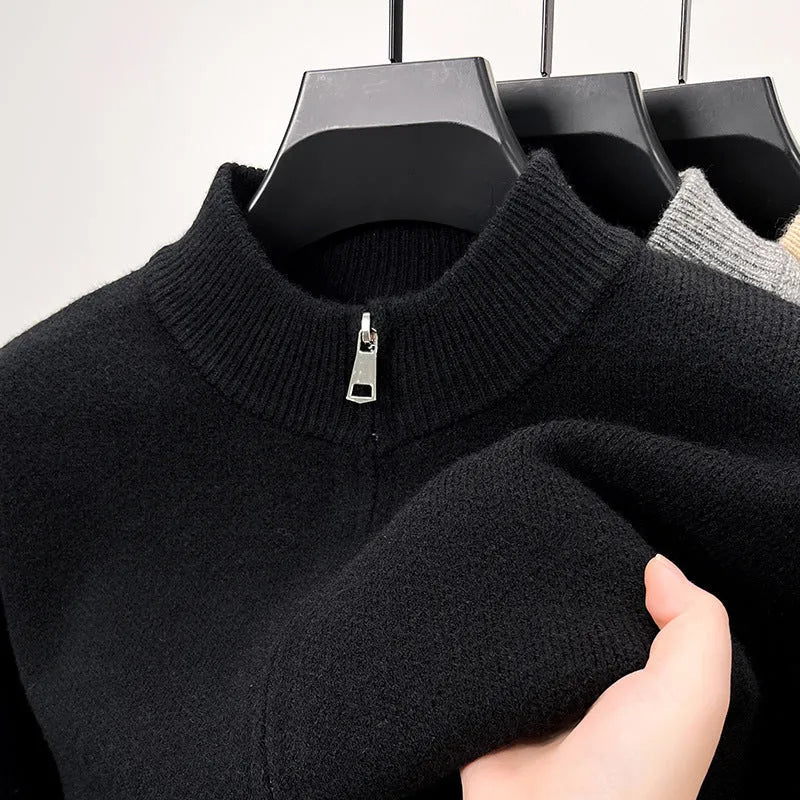 Man wearing a loose-fit, grey, stand collar knitted cardigan with a full-length front zipper.