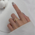 A geometric copper leaf-shaped ring for women, shown in both gold and silver electroplated finishes.