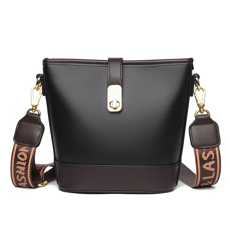Soft black PU bucket style messenger bag with double shoulder straps, shown open to reveal internal organiser pockets.