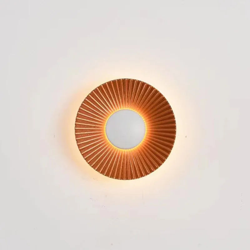 Round aluminium wall lamp mounted on a wall, showing LED illumination.