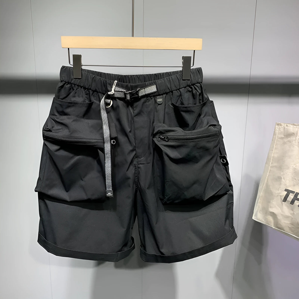 Men's loose fit workwear shorts in black or grey with pockets and straight leg hem available in large sizes