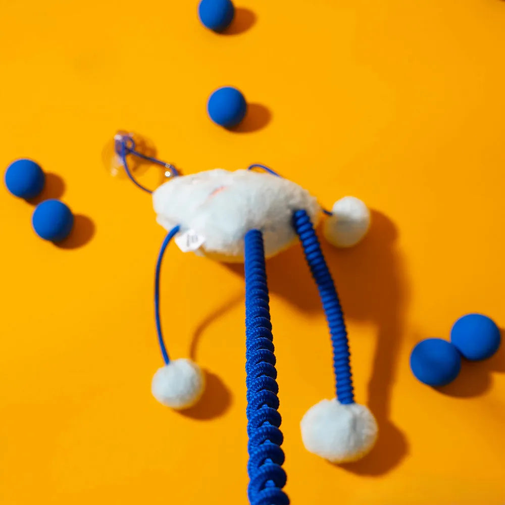 Blue telescopic elastic cat toy with plush element and mint-scented bell ring extended during play