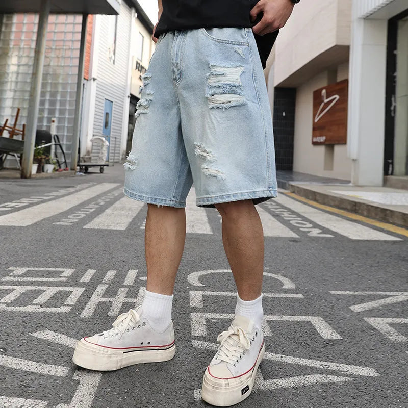 Light blue ripped denim shorts with loose straight-leg cut and distressed detailing on mannequin