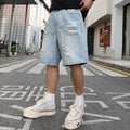 Light blue ripped denim shorts with loose straight-leg cut and distressed detailing on mannequin